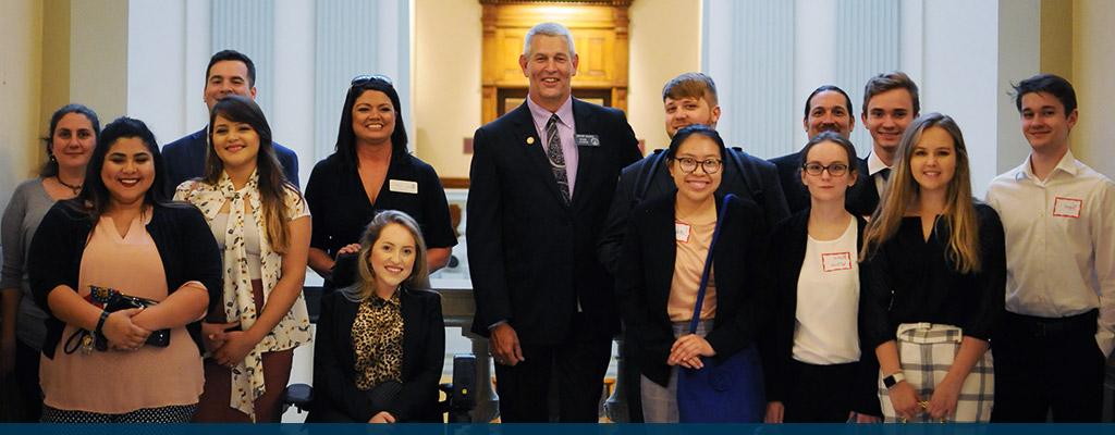 Students posing with government official